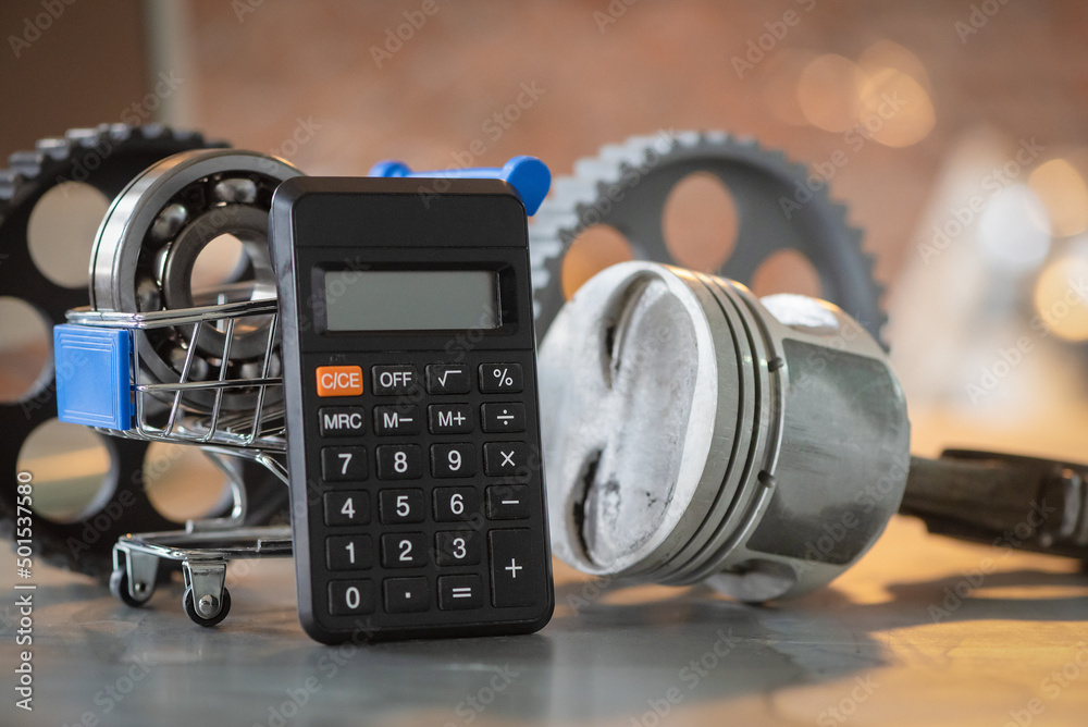 Car repair costs concept. Automobile spare parts cost estimate. Calculator, engine piston and