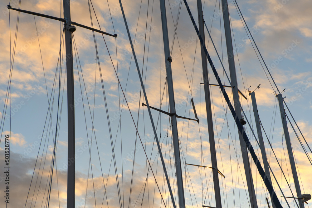 Yacht masts on beautiful morning sky background