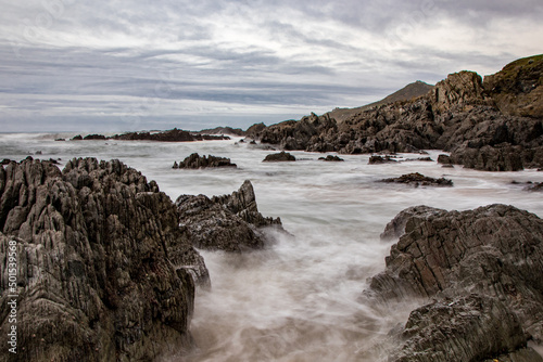 Wallpaper Mural Dramatic rocks in the sea in North Devon, with a cool November sky.  A long exposure adds movement and mystery. Torontodigital.ca