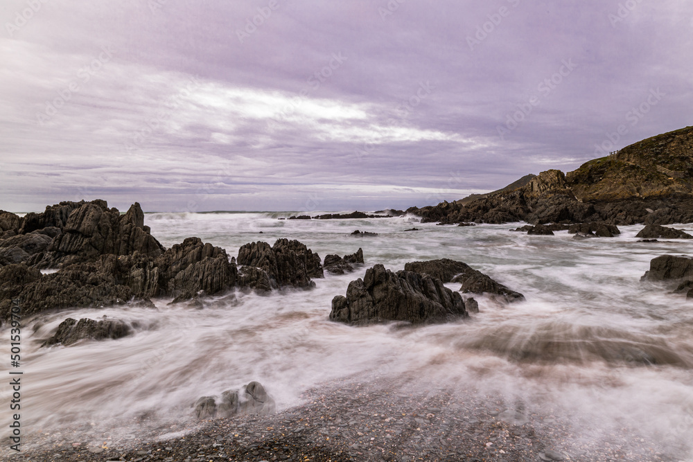 The rocks on this North Devon Beach are lapped by the sea on a cold November day. The rocks on this North Devon Beach are lapped by the sea on a cold November day.