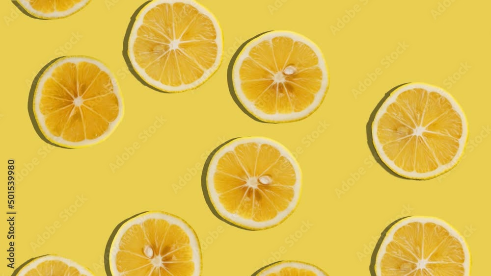 Background of lemon slices falling. Fresh fruit. Loop. 4K.