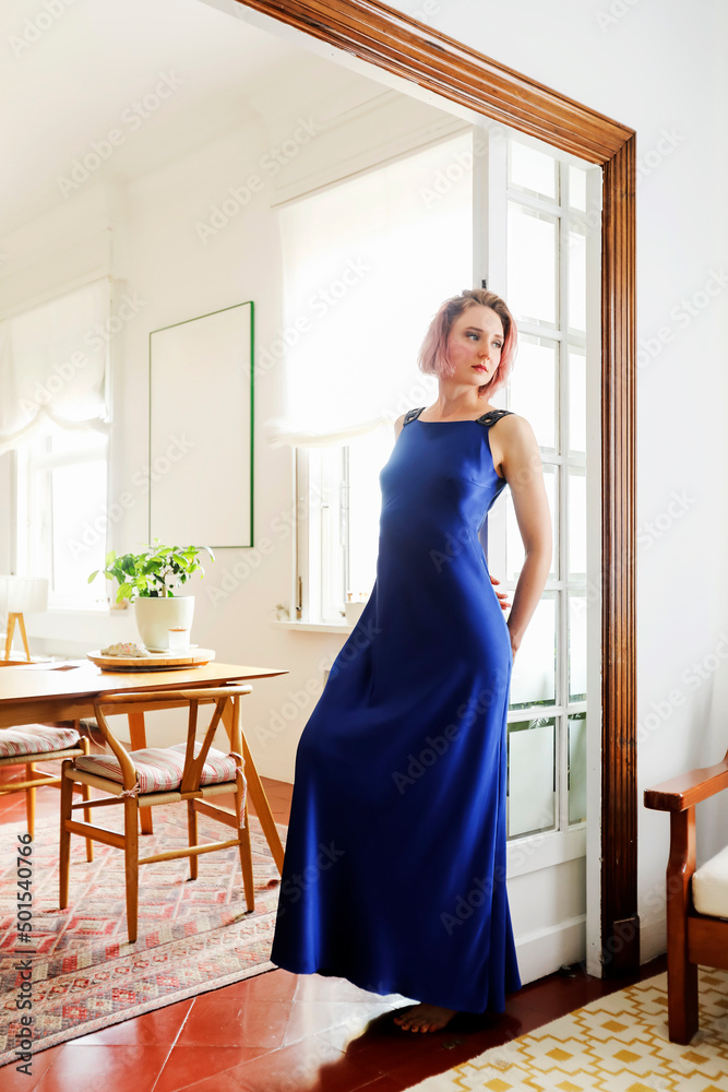 young beautiful lady wearing a blue dress posing in the living room young beautiful lady wearing a blue dress posing in the living room