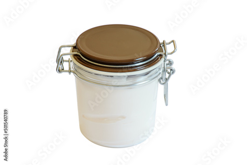 Glass jar with brown lid and metal latch with coconut oil