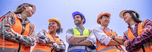 Group engineers stand smiling happily working safety first,wearing hard hats, reflective vests.Workers various nationalities, African,Middle Eastern, Western,Asian,Thai,working together banner cover.