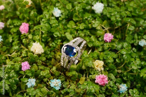 Women's platinum ring with a diamonds and blue precious sapphire jemstone photo