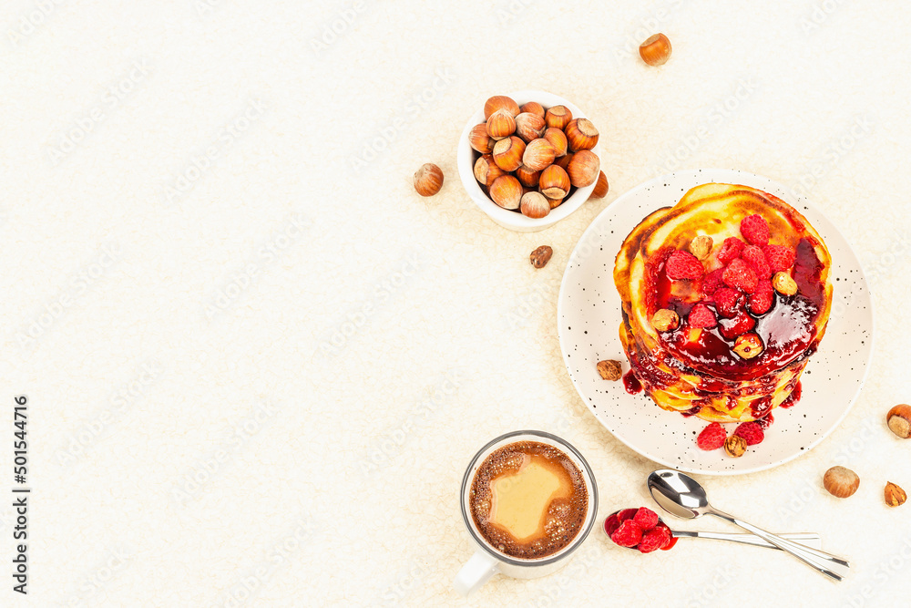 Traditional homemade breakfast with pancakes and coffee. Raspberry, hazelnut, sweet jam Traditional homemade breakfast with pancakes and coffee. Raspberry, hazelnut, sweet jam