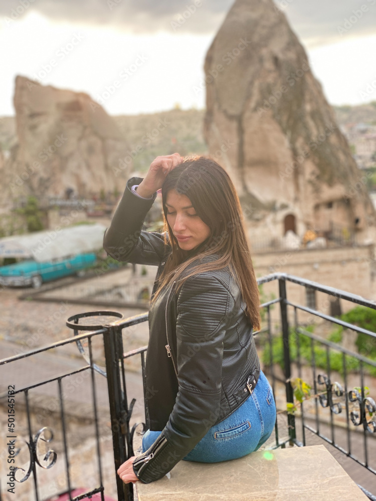 Back view of young girl standing on terrace in Cappadocia.