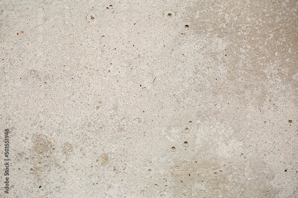Heterogeneous concrete background of gray-beige color with inclusions, close-up Heterogeneous concrete background of gray-beige color with inclusions, close-up