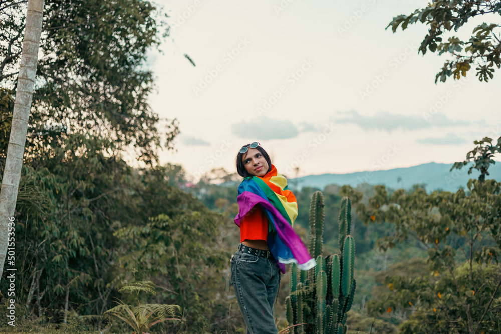 Non-binary person embraces a rainbow flag
Non-binary person embraces a rainbow flag