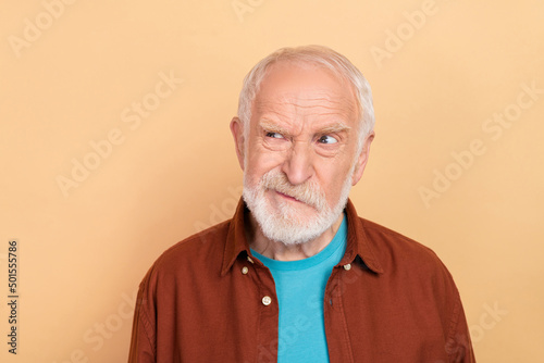 Photo of sad aged white hairdo man look promo wear brown shirt isolated on beige color background photo