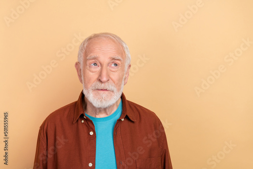 Photo of strict old grey hairdo man look promo wear brown shirt isolated on beige color background