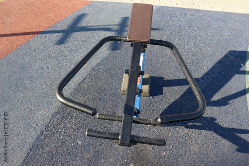 trainers and horizontal bars in city yard