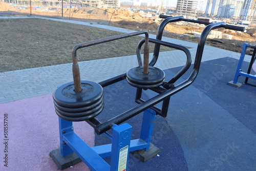 trainers and horizontal bars in city yard