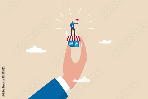 Small business idea, successful entrepreneur with small retail shop or storefront, shop owner or merchandise opportunity concept, success businessman holding winner flag on small store in giant hand.