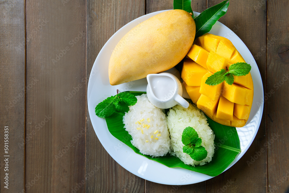 Top view of Ripe Mango with Coconut Flavored Sticky Rice on wood dish, Top view of Ripe Mango with Coconut Flavored Sticky Rice on wood dish,