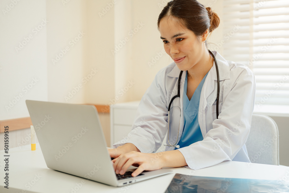 Asian woman doctor in uniform greeting patients online on laptop during on line meeting. Asian woman doctor in uniform greeting patients online on laptop during on line meeting.