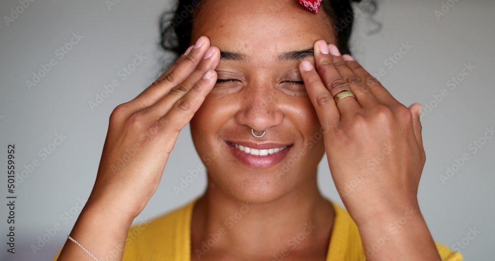 Pensive black woman rubbing face with hands thinking Pensive black woman rubbing face with hands thinking