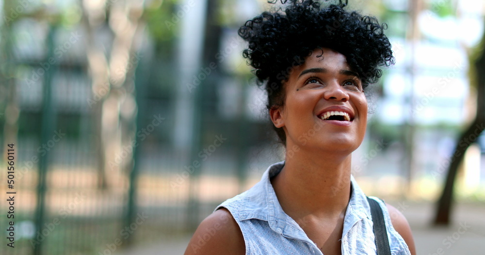 Mixed race young woman standing outside smiling Mixed race young woman standing outside smiling