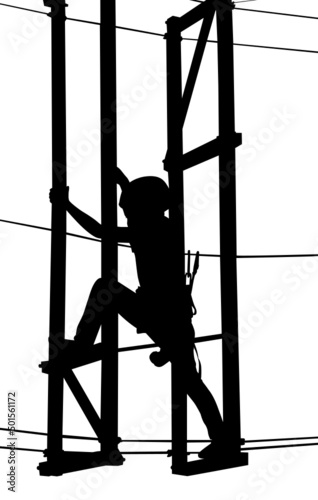 boy in adventure park rope ladder.in adventure park rope ladder. Silhouette Adventure. Woman on cables in an adventure park on a difficult course	