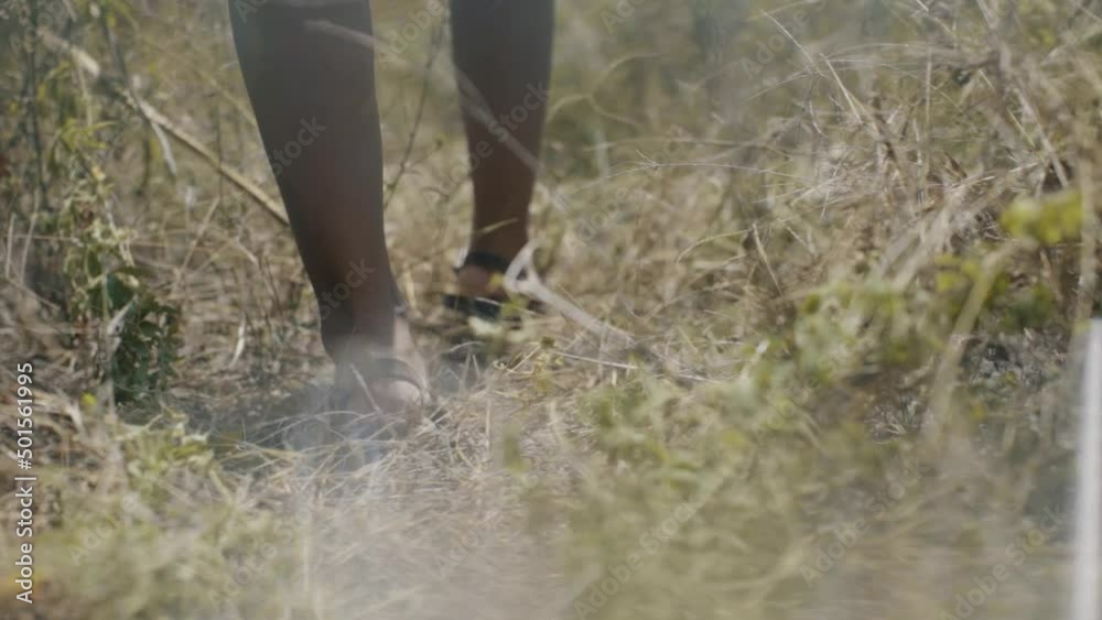 close up feet walking in the field at daytime in slow motion close up feet walking in the field at daytime in slow motion