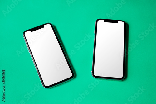 Double smartphone screen mockup above flat paper texture by real photography photo