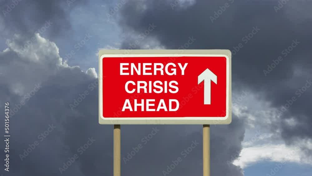 Zoom in to a road sign indicating an approaching Energy Crisis with a background of timelapse clouds. A worldwide shortage of fuel of gas and oil. Zoom in to a road sign indicating an approaching Energy Crisis with a background of timelapse clouds. A worldwide shortage of fuel of gas and oil.