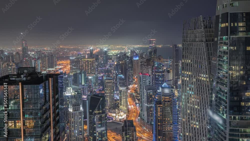 Skyline panoramic view of Dubai Marina showing canal surrounded by skyscrapers along shoreline night timelapse. DUBAI, UAE Skyline panoramic view of Dubai Marina showing canal surrounded by skyscrapers along shoreline night timelapse. DUBAI, UAE