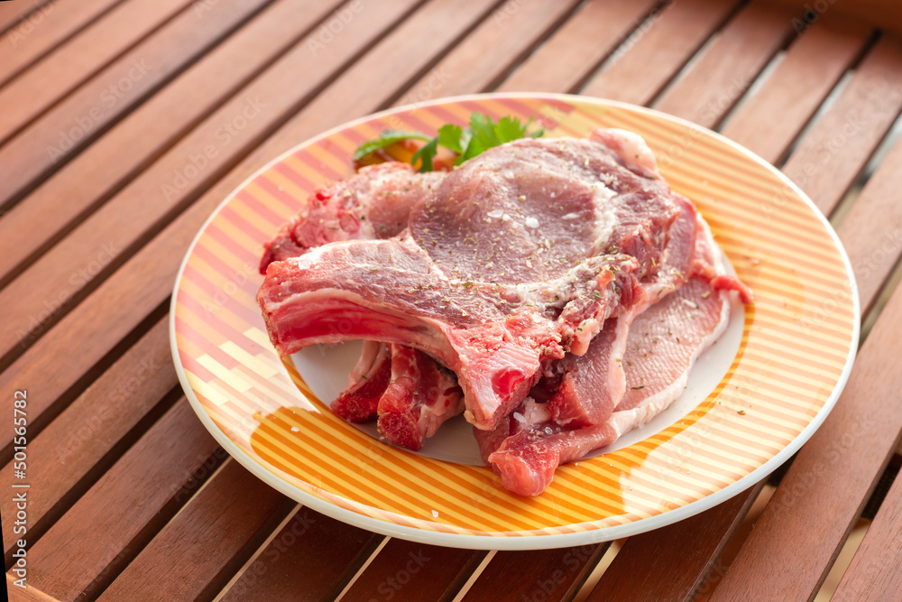 raw meat with marinate and herbs on dish raw meat with marinate and herbs on dish