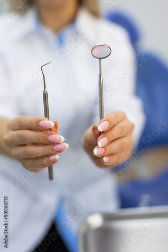 dentist tools in the hands of a female doctor
