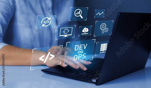 Agile programming and DevOps concept. Engineer working on laptop with virtual screen. IT operations, high software quality and software development. photo