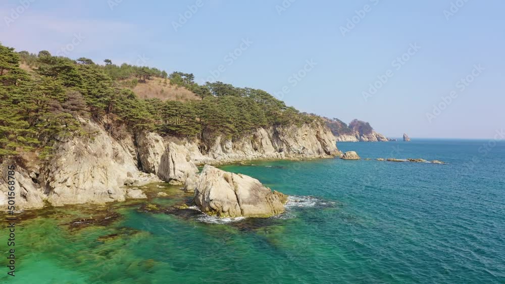Aerial view of the rocky seashore of a beautiful bay with transparent water Aerial view of the rocky seashore of a beautiful bay with transparent water