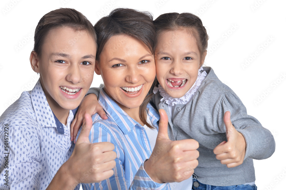 Happy smiling mother and children showing thumbs up together on white background Happy smiling mother and children showing thumbs up together on white background