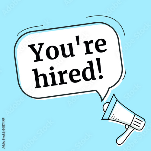 Male hand holding megaphone with you're hired speech bubble. Loudspeaker.