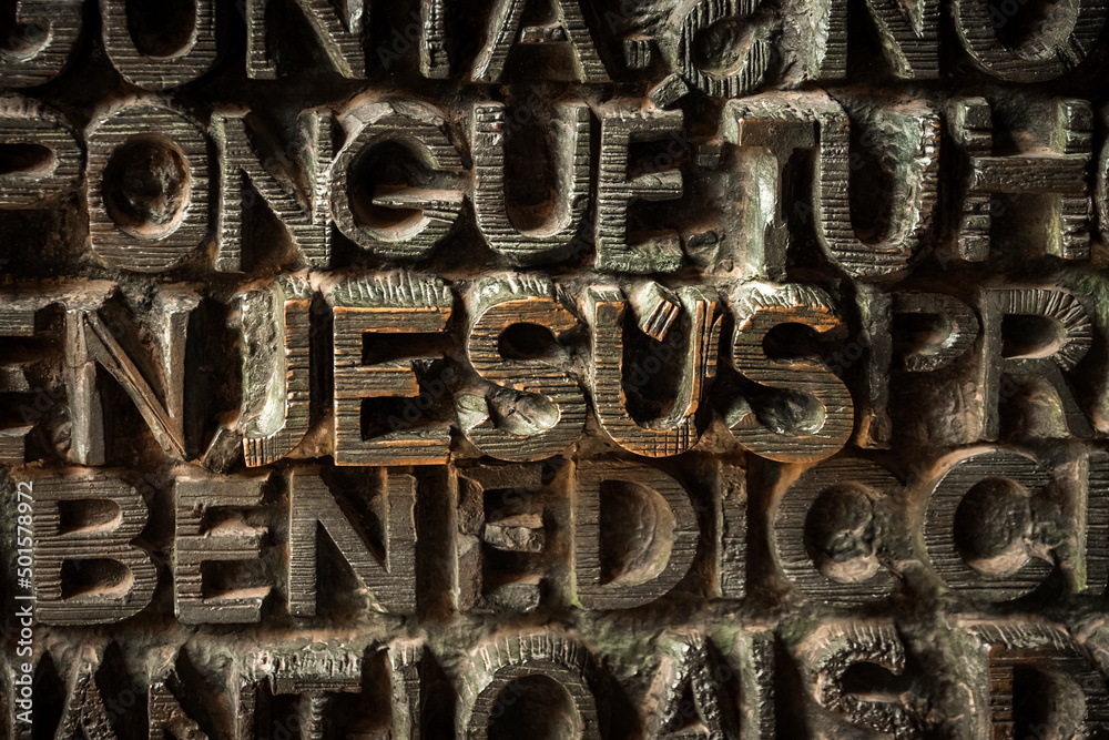 the entrance door of the sagrada familia in barcelona is characterized by all words about christianity. In this photo closeup of the word Jesus the entrance door of the sagrada familia in barcelona is characterized by all words about christianity. In this photo closeup of the word Jesus