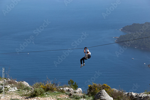 Obraz na płótnie Man going down on rope above Adriatic sea. Adventure attraction near Dubrovnik. Croatia. w salonie