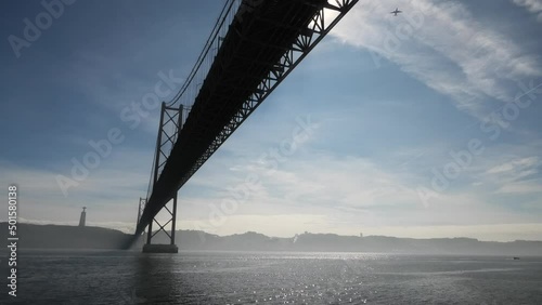 Ponte 25 de Abril, Taj-Tagus in Lisbon, Portugal with in the background Cristo-Rei photo