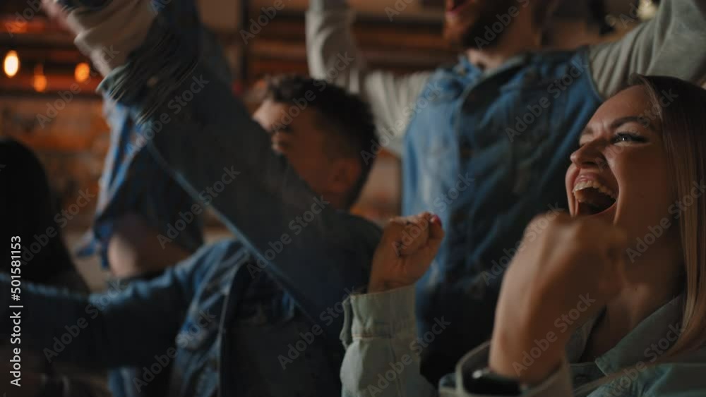 Crowd of spectators cheering at sports event, man and woman holding a glass of beer. football team supporters actively jumping and chanting in crowd. Crowd of spectators cheering at sports event, man and woman holding a glass of beer. football team supporters actively jumping and chanting in crowd.