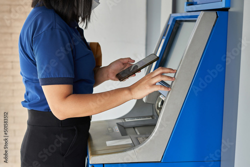 Person using by push button ATM machine. 