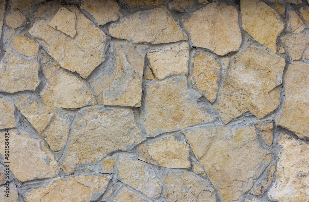 The texture of a stone wall. A stone wall as a background or texture.