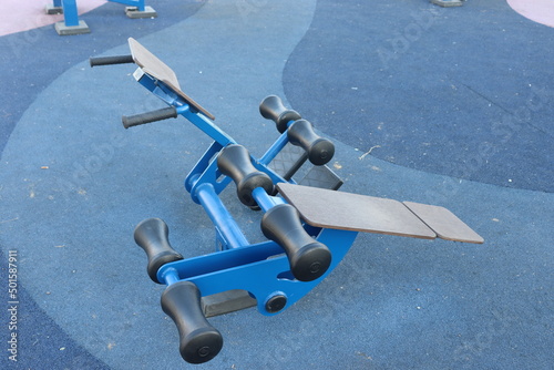 trainers and horizontal bars in city yard