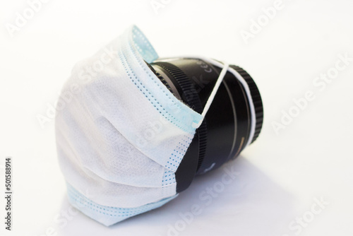 Optical lens for photo camera lies in a protective medical mask