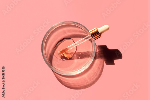 Laboratory glass petri with pipette and drop of water, serum, oil, beauty product. Natural medicine, cosmetic research, bio science. Concept of skincare and analysis. Dermatology. Flat lay, top view