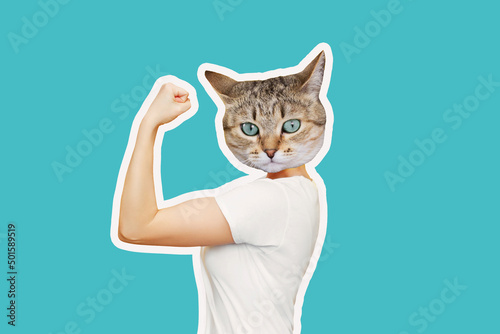 Strong woman headed by cat head raises arm and shows bicep isolated on a color blue background. Support animal rights, activism. Trendy collage in magazine style. Contemporary art. Modern design © Марина Демешко