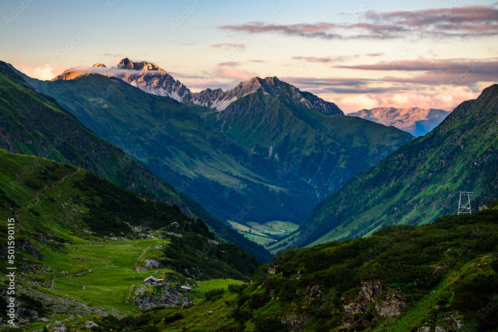 Kalkkögel mountain range with its highest peak Schlicker Seespitze and Hoher Burgstall in Stubai Alps in orange sunset light. 