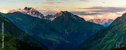 Kalkkögel mountain range with its highest peak Schlicker Seespitze and Hoher Burgstall in Stubai Alps in orange sunset light. 