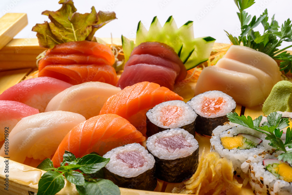 Japanese food mix including sushi and sashimi on wooden barge. Japanese food mix including sushi and sashimi on wooden barge.