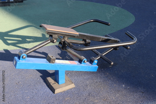 trainers and horizontal bars in city yard