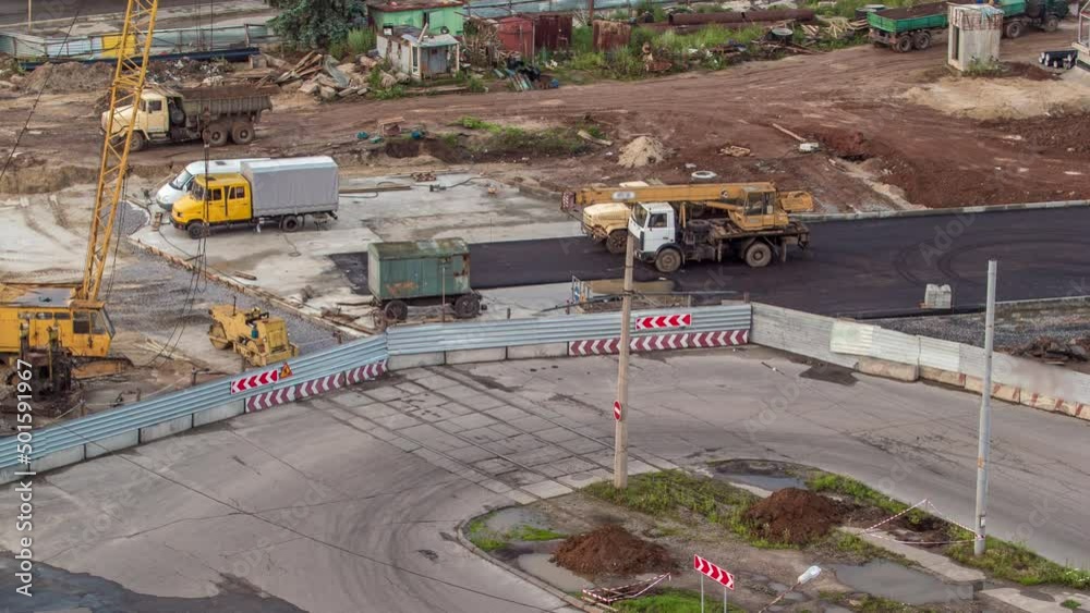 Aerial view of large road construction site with several industrial machines timelapse.