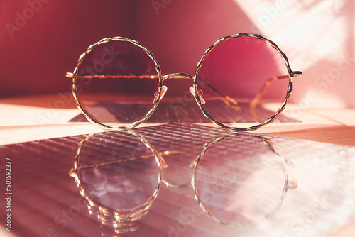 Canvas Studio shot of trendy female sunglasses in coral tones for summer