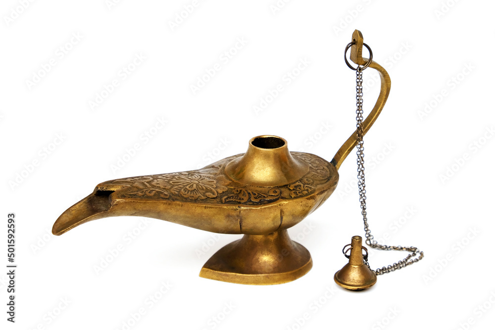 An old, fabulous, magic lamp made of yellow metal, with the lid removed, isolated on a white background. An old, fabulous, magic lamp made of yellow metal, with the lid removed, isolated on a white background.